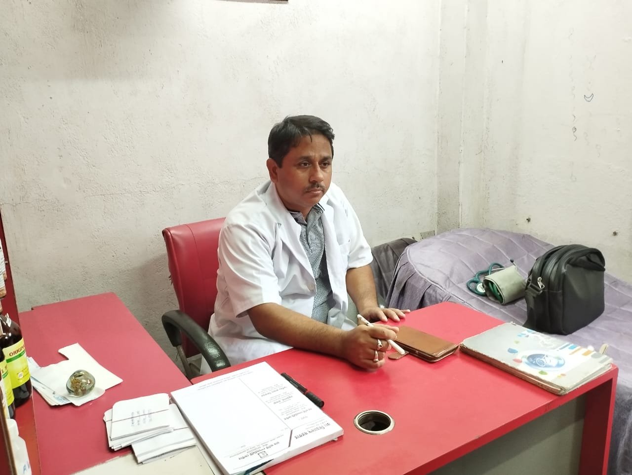 Dr N Sarkar sitting in chamber at Roy Multi Speacility Centre Best Homeopathy Clinic in Gaighata